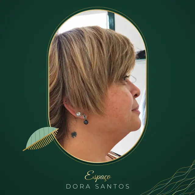 Cliente de perfil com cabelo curto loiro escuro com mechas claras, franja lateral longa e nuca curta, numa moldura dourada em cápsula
